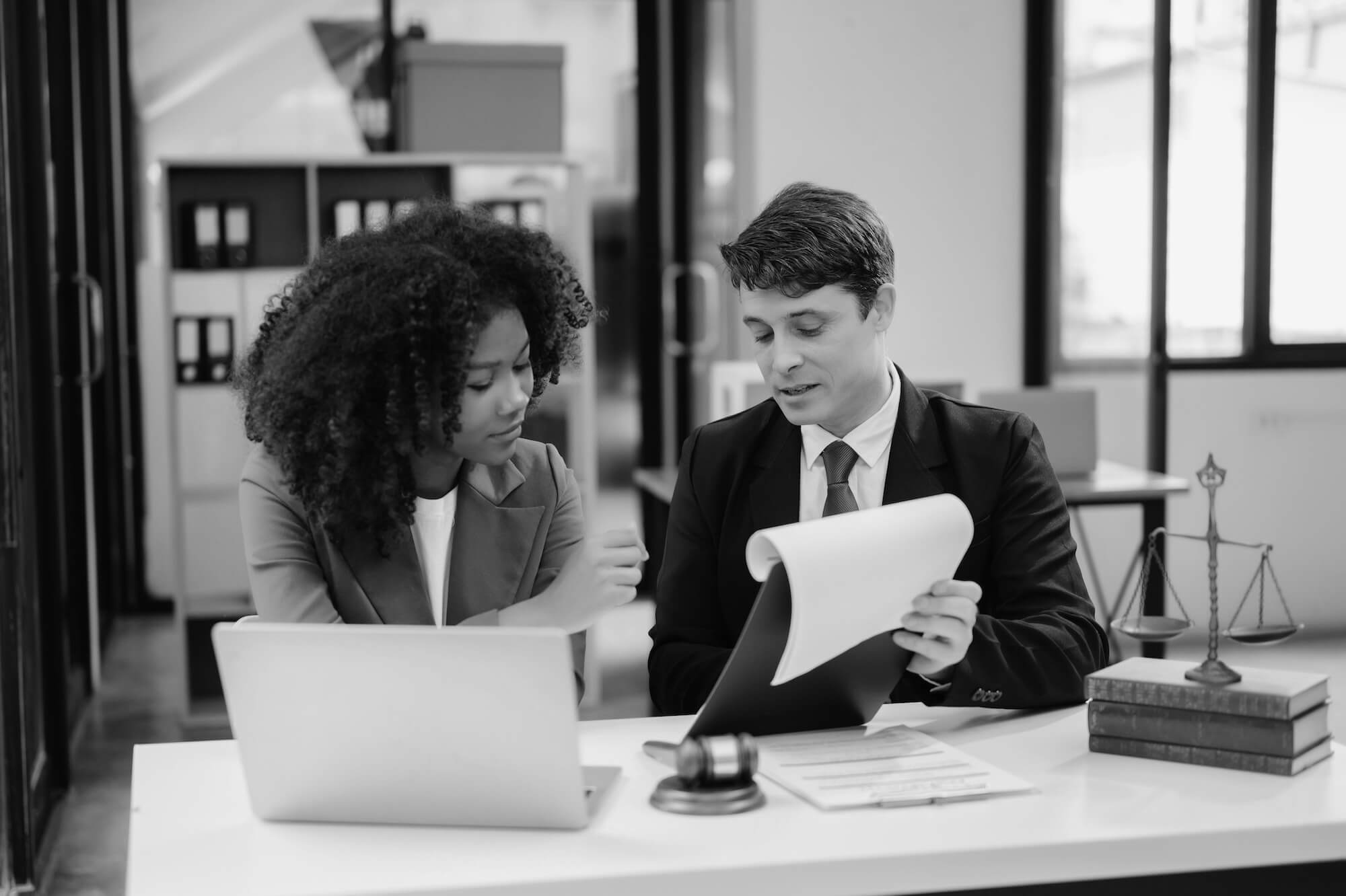 Solicitor reviewing documents and evidence with a client as part of a professional negligence claim in the UK