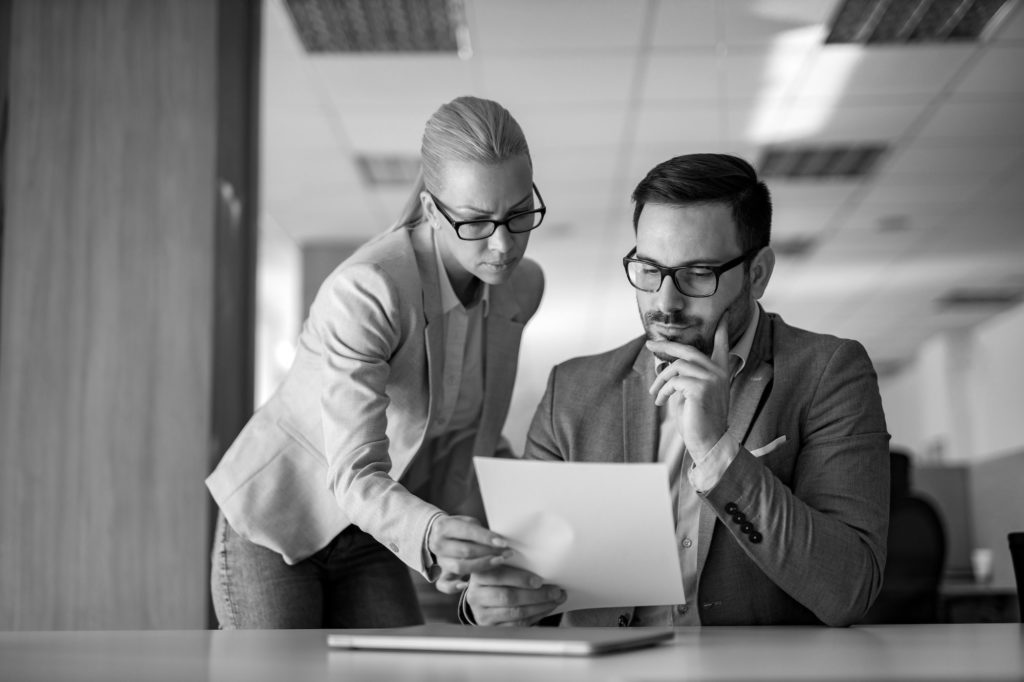 Financial services professionals reviewing regulatory compliance documents as part of the FCA licensing and authorisation process