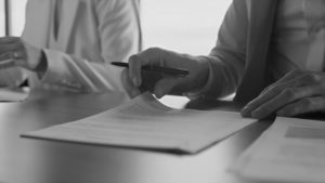 Business shareholders reviewing a shareholder agreement to establish ownership rights and responsibilities within a company.