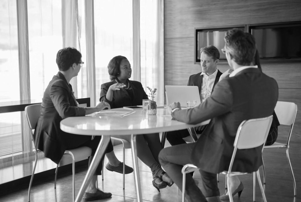 Business professionals attending a mediation meeting to resolve a commercial dispute through alternative dispute resolution (ADR)