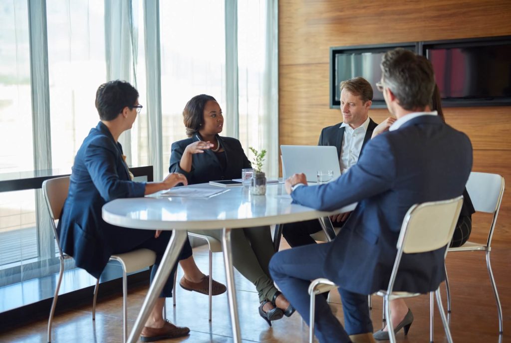 Business professionals attending a mediation meeting to resolve a commercial dispute through alternative dispute resolution (ADR)