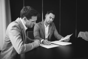 Landlord and commercial tenant reviewing lease documents during a commercial lease renewal dispute